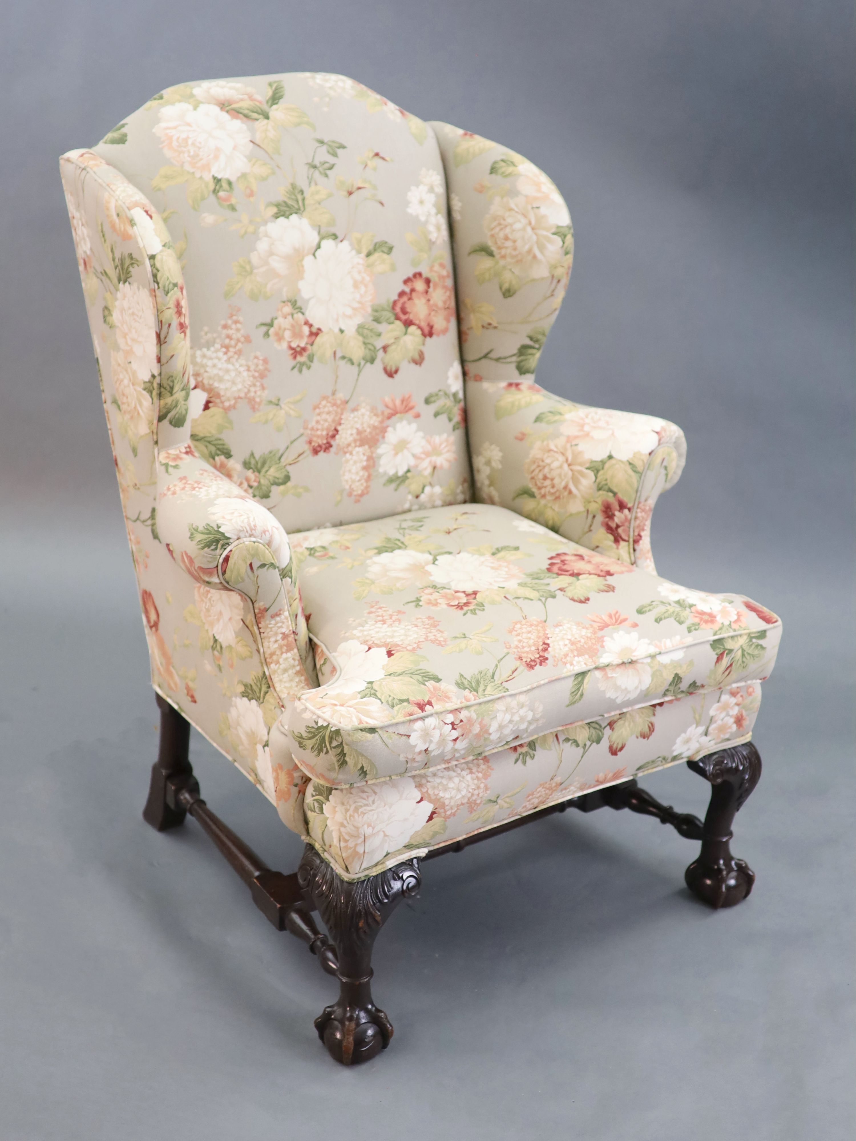 A Chippendale revival wing armchair together with a matching contemporary footstool